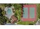 Aerial view of the community pool and tennis courts surrounded by greenery and landscaping at 4018 August Ct, Casselberry, FL 32707