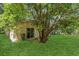 Expansive backyard features lush green grass and mature tree, offering a private oasis at 4018 August Ct, Casselberry, FL 32707