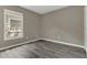 This bedroom features wood-look floors, and a window providing natural light at 4018 August Ct, Casselberry, FL 32707