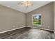 Bedroom with wood-look flooring and a window for natural light at 4018 August Ct, Casselberry, FL 32707
