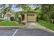 Charming one-story home with lush lawn, palm tree, and attached single-car garage at 4018 August Ct, Casselberry, FL 32707