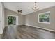 Spacious living room featuring hardwood floors, vaulted ceiling with fan, and natural light at 4018 August Ct, Casselberry, FL 32707