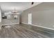 Inviting living room with hardwood floors, ceiling fan, and a view into the kitchen at 4018 August Ct, Casselberry, FL 32707
