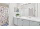 Bathroom featuring double sinks, a large mirror, and updated cabinets at 4478 Yachtmans Ct, Orlando, FL 32812