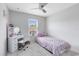 Cozy bedroom featuring an updated ceiling fan and a large window at 4478 Yachtmans Ct, Orlando, FL 32812