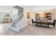 Open-concept dining room features hard wood floors and a staircase leading to the second floor at 4478 Yachtmans Ct, Orlando, FL 32812