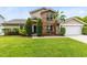Charming two-story home with brick accents, manicured lawn, and a blue front door at 4478 Yachtmans Ct, Orlando, FL 32812