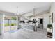 Bright kitchen with white cabinets, stainless steel appliances, island with seating, and sliding glass doors to backyard at 4478 Yachtmans Ct, Orlando, FL 32812