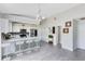 Bright kitchen with white cabinets, stainless steel appliances, an island with seating and modern light fixture at 4478 Yachtmans Ct, Orlando, FL 32812