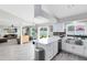 Open-concept kitchen featuring an island with seating, white cabinetry and stainless steel appliances at 4478 Yachtmans Ct, Orlando, FL 32812