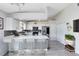 Bright kitchen featuring white cabinets, stainless steel appliances, and an island with seating at 4478 Yachtmans Ct, Orlando, FL 32812