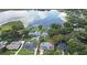 Aerial view of a charming home near a lake, complete with a refreshing pool and lush greenery at 448 Stonewood Ln, Maitland, FL 32751