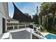 Backyard deck with gray planking and featuring shade screen and tropical foliage at 448 Stonewood Ln, Maitland, FL 32751