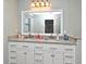 Bathroom vanity with granite countertops, double sinks and white cabinets at 448 Stonewood Ln, Maitland, FL 32751