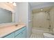 Well-lit bathroom with updated vanity, classic tile, and tub with shower at 448 Stonewood Ln, Maitland, FL 32751