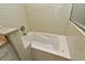 Close-up of bathtub featuring white tile surround with granite countertop and jets at 448 Stonewood Ln, Maitland, FL 32751
