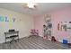 Bright bedroom features gray wood floors, ceiling fan, and playful decor at 448 Stonewood Ln, Maitland, FL 32751