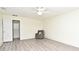Spacious bedroom featuring light gray laminate flooring, neutral paint, and a ceiling fan at 448 Stonewood Ln, Maitland, FL 32751