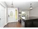 Versatile bonus room featuring hardwood floors, a pool table, built-in bookshelves and decorative pendant lighting at 448 Stonewood Ln, Maitland, FL 32751