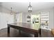 Bonus room with wood floors, large table, built-in shelving, contemporary light fixtures and abundant natural light at 448 Stonewood Ln, Maitland, FL 32751