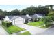 Charming single-story home with a well-manicured lawn, neutral paint, a two-car garage, and a beautiful gray brick paver driveway at 448 Stonewood Ln, Maitland, FL 32751