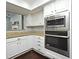 Updated kitchen with granite countertops, stainless steel appliances, and white cabinets at 448 Stonewood Ln, Maitland, FL 32751