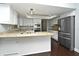 Modern kitchen features granite countertops, stainless steel appliances, and white cabinetry at 448 Stonewood Ln, Maitland, FL 32751