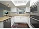 Well-lit kitchen with stainless steel appliances, granite counters and a view to the Gathering room at 448 Stonewood Ln, Maitland, FL 32751