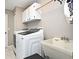 Laundry room with washer, dryer, utility sink and storage cabinets at 448 Stonewood Ln, Maitland, FL 32751