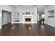 Bright living room featuring a fireplace, vaulted ceilings, and sleek dark wood floors at 448 Stonewood Ln, Maitland, FL 32751