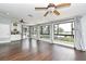 Living room with hardwood floors, ceiling fans, and bright view to the exterior at 448 Stonewood Ln, Maitland, FL 32751