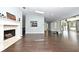 Open living room featuring fireplace, wood floors, and easy access to kitchen at 448 Stonewood Ln, Maitland, FL 32751