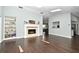Bright living room featuring a fireplace, built-in shelves, and elegant wood floors at 448 Stonewood Ln, Maitland, FL 32751