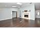 Bright living room featuring a fireplace, vaulted ceilings, and elegant wood floors at 448 Stonewood Ln, Maitland, FL 32751