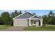 Charming single-Gathering home with a blue and grey exterior and a well-manicured lawn at 4548 Ochos Rios Pl, Kissimmee, FL 34758