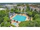Aerial view of a community pool with a lap area, sun loungers, and nearby shade trees at 4584 Virginia Dr, Orlando, FL 32814