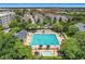 An aerial shot of a community pool featuring clear blue water and ample lounge seating for residents at 4584 Virginia Dr, Orlando, FL 32814