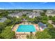 Aerial view showcasing the community pool, surrounded by seating and lush greenery, with residential buildings nearby at 4584 Virginia Dr, Orlando, FL 32814