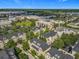 An aerial view of a neighborhood offering a mix of residential and commercial properties near a serene lake at 4584 Virginia Dr, Orlando, FL 32814