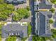 An aerial view of a charming community featuring lush trees, convenient parking, and well-maintained townhomes at 4584 Virginia Dr, Orlando, FL 32814