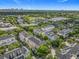 This aerial view displays a townhome community with mature trees, blending residential charm with natural beauty at 4584 Virginia Dr, Orlando, FL 32814