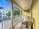Inviting balcony with column supports, wicker furniture, and scenic neighborhood views at 4584 Virginia Dr, Orlando, FL 32814