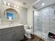 Stylish bathroom showcasing a modern vanity, toilet, and a sleek glass-enclosed shower at 4584 Virginia Dr, Orlando, FL 32814