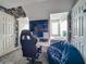 Bedroom featuring a black gaming chair, built-in bed, and unique wall decor at 4584 Virginia Dr, Orlando, FL 32814