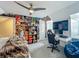 This spacious bedroom features carpet, a ceiling fan, and a creative wall art display at 4584 Virginia Dr, Orlando, FL 32814