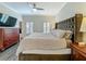 Stylish bedroom with a dark wood dresser, ceiling fan, and plenty of room for unwinding at 4584 Virginia Dr, Orlando, FL 32814