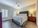 Bright bedroom featuring a comfortable bed, wood floors, and ample natural light, creating a relaxing ambiance at 4584 Virginia Dr, Orlando, FL 32814