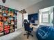 Bedroom with a black gaming chair, a mounted monitor, and a built-in bed at 4584 Virginia Dr, Orlando, FL 32814