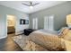 Well-lit bedroom featuring a large bed, ceiling fan, plantation shutters, and access to an en-suite bathroom at 4584 Virginia Dr, Orlando, FL 32814