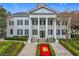 An elegant two-story clubhouse with stately columns and a well-manicured entrance greets residents and guests at 4584 Virginia Dr, Orlando, FL 32814
